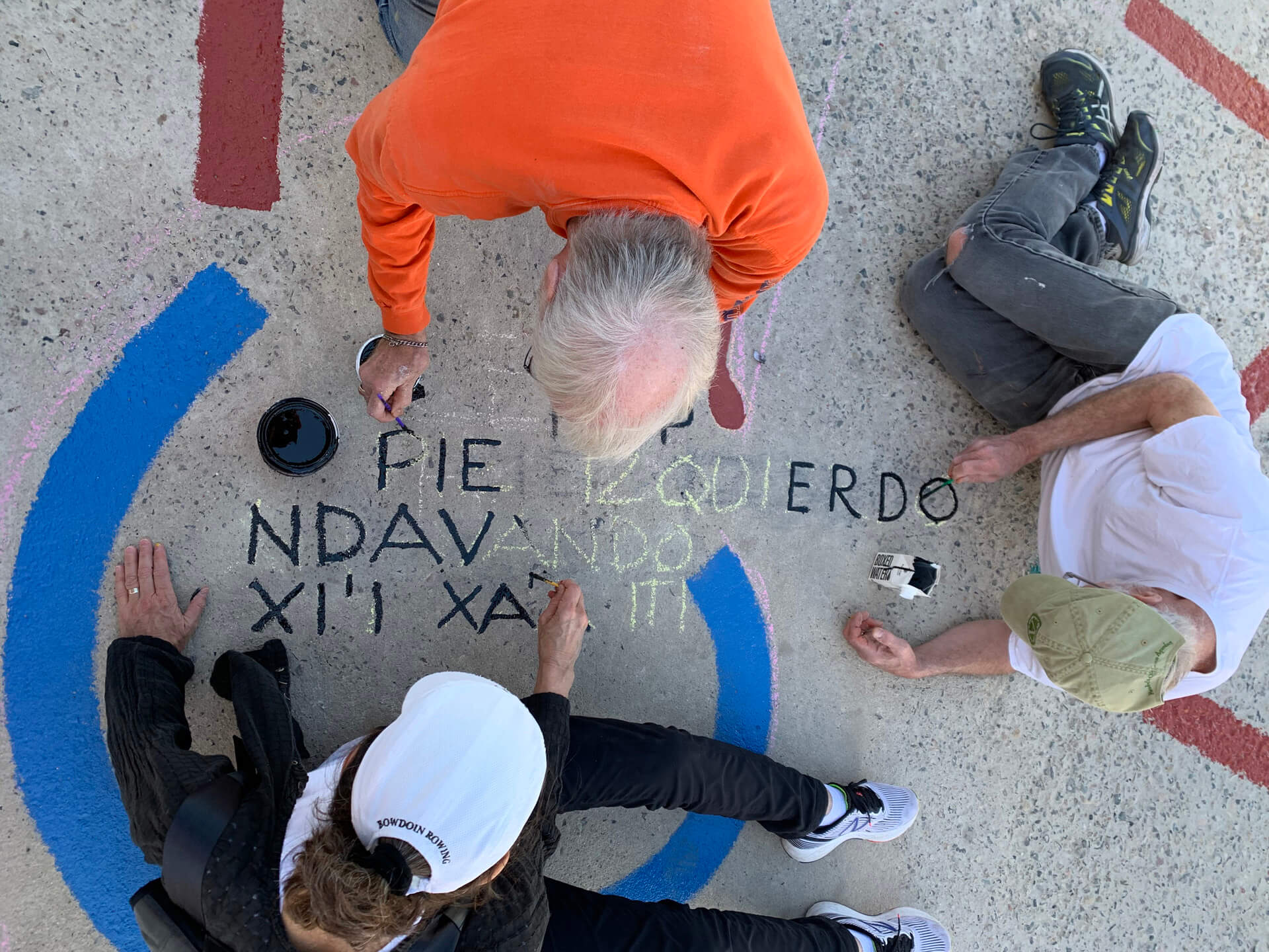 Loeb Fellows painting a playground design created by David Molander and Matthew Mazzotta