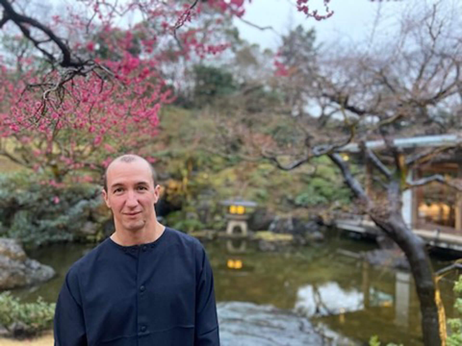 Henry Grabar in Japanese garden with cherry blossoms overhead