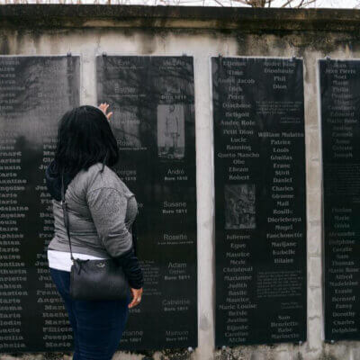 Viewer at memorial showing names of enslaved persons